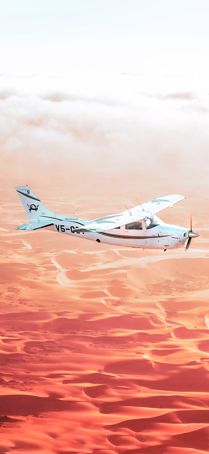 wallpaper of White Airplane Flying Over The Desert