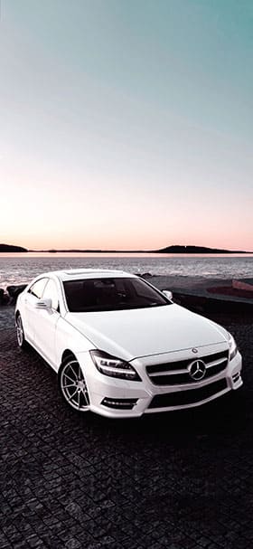 white mercedes cls parked near sea phone wallpaper