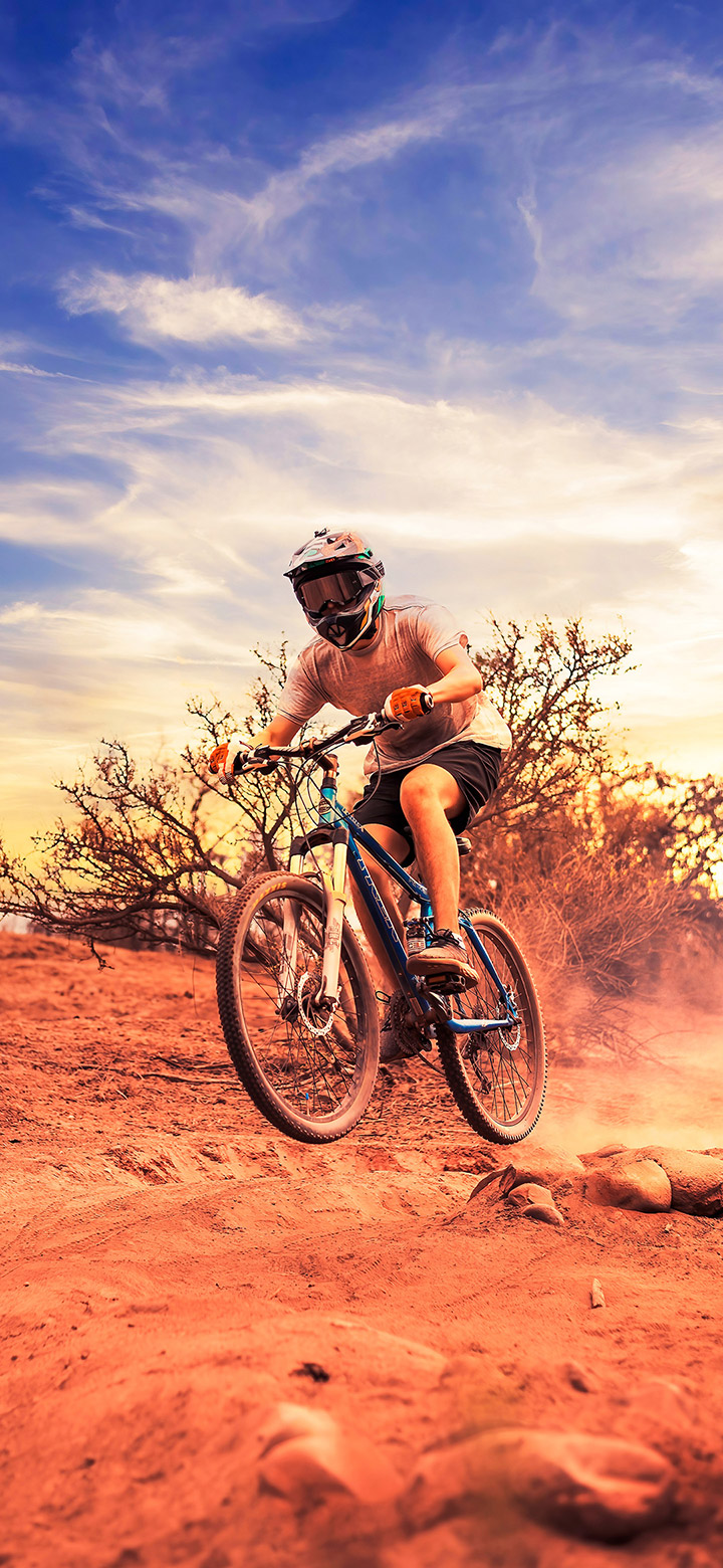 wallpaper of Man Riding A Bike In The Desert