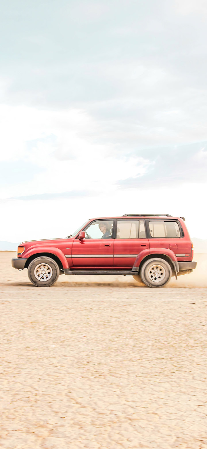 wallpaper of Red Suv Car In Sahara