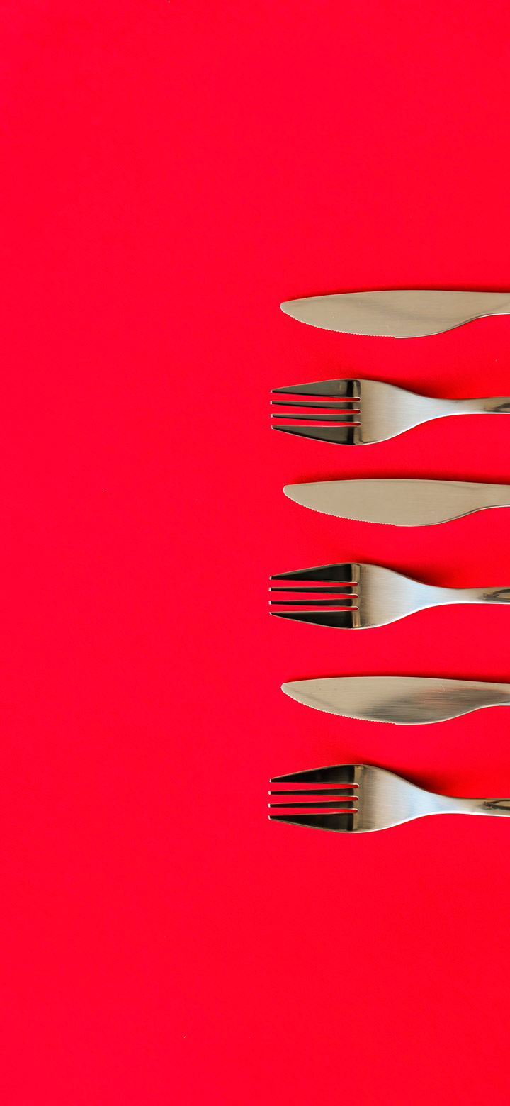 wallpaper of silver cutlery on a red table