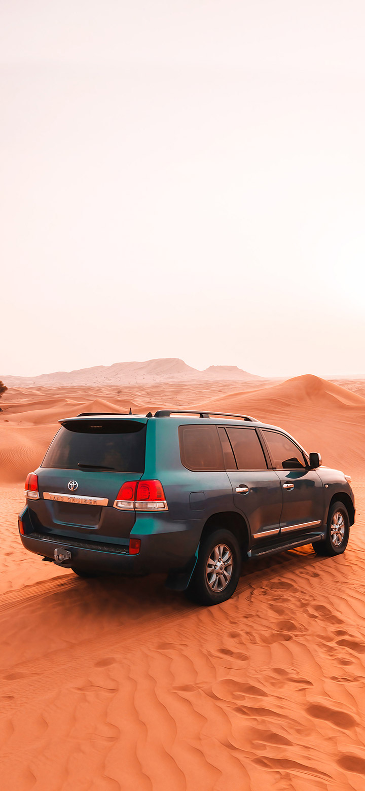 wallpaper of Toyota SUV Car On Brown Sand
