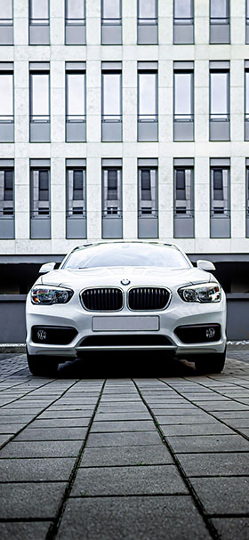 Phone Wallpaper of BMW Parked On A Gray Sidewalk