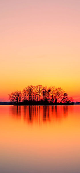 wallpaper of orange sunset over body of water