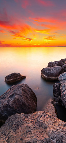 iPhone wallpaper of orange sunset over the calm sea