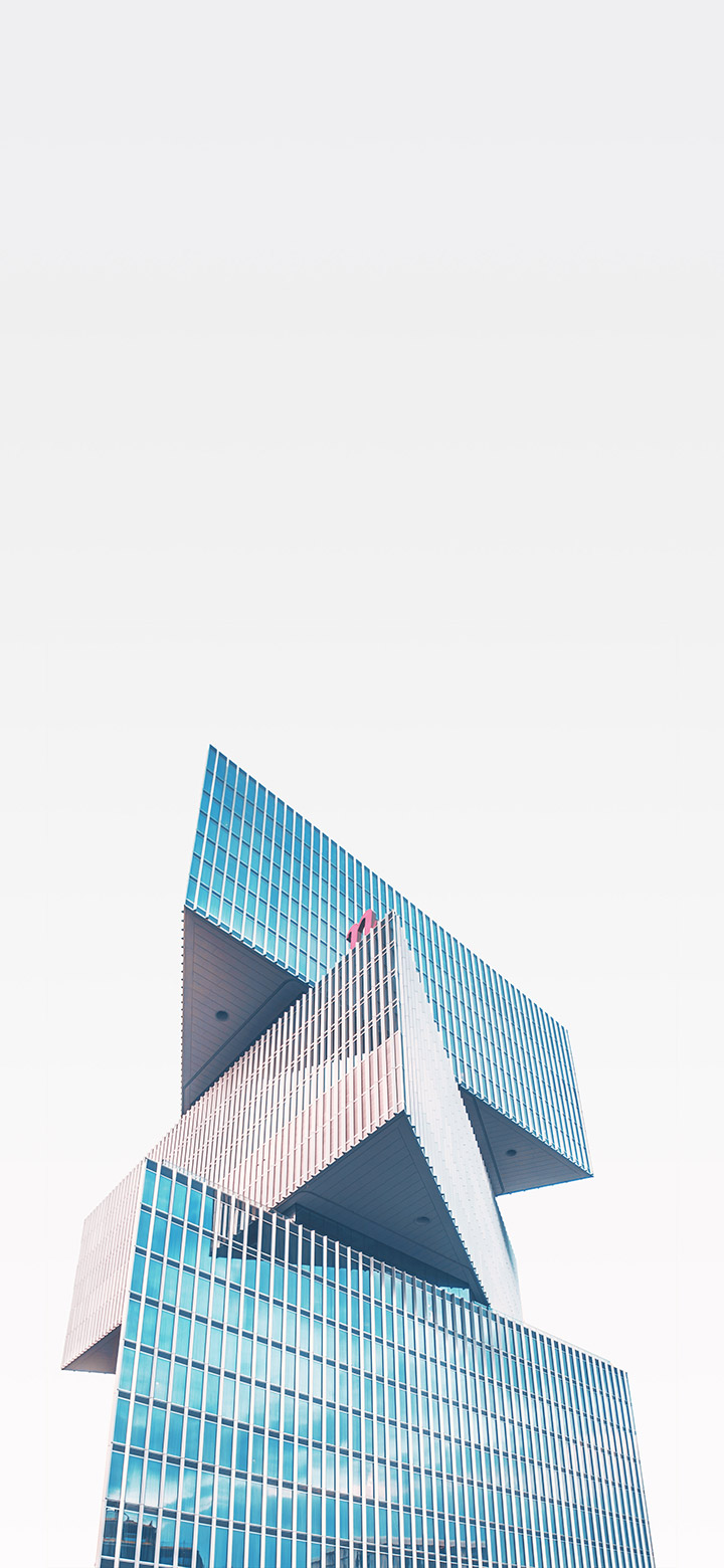 wallpaper of Simple glass building with sharp angles under a clear sky