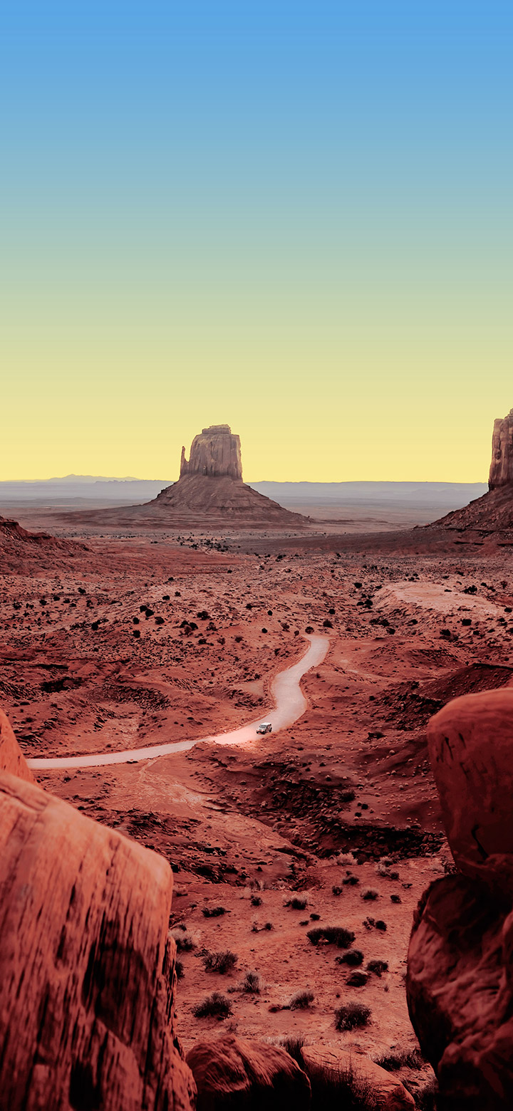 wallpaper of Desert scene with a narrow road passing across