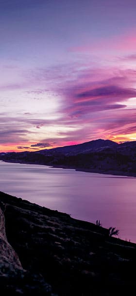 Phone Wallpaper of Dark purple river under cloudy sky