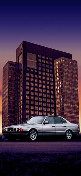 Phone wallpaper of Classic BMW parked near a building