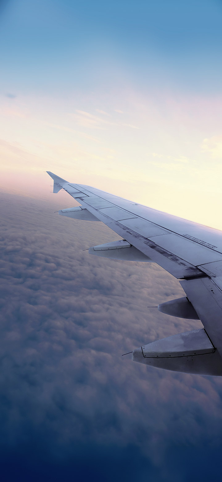 wallpaper of airplane wing above aesthetic clouds