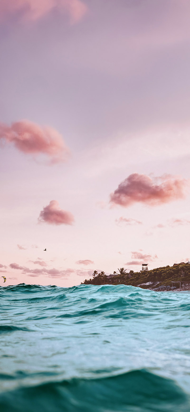 wallpaper of pink sky over turquoise sea water