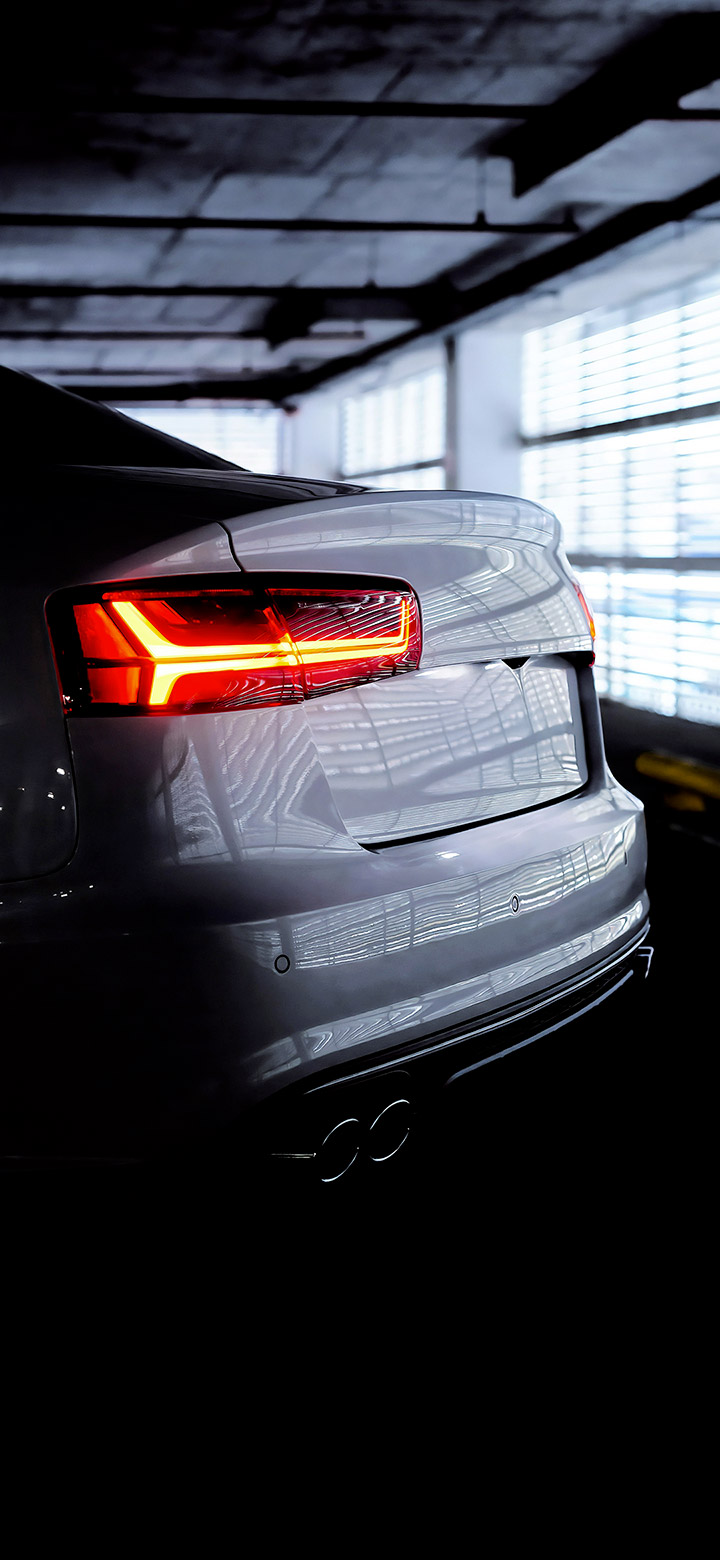 wallpaper of the back of an audi car in a dark garage