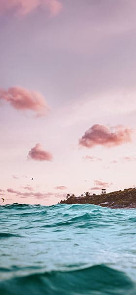 Phone wallpaper of Pink sky over turquoise sea water