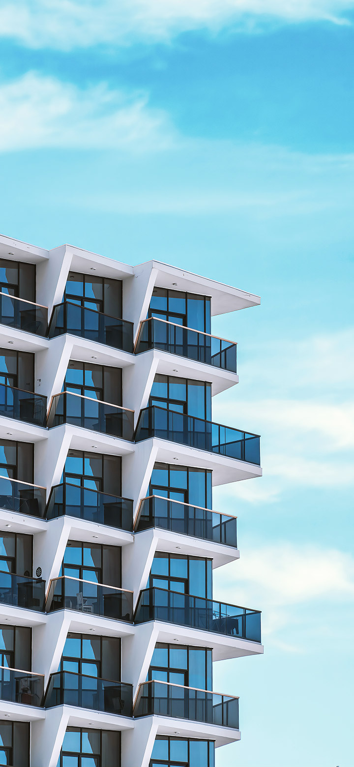 wallpaper of tall building with balconies and blue windows