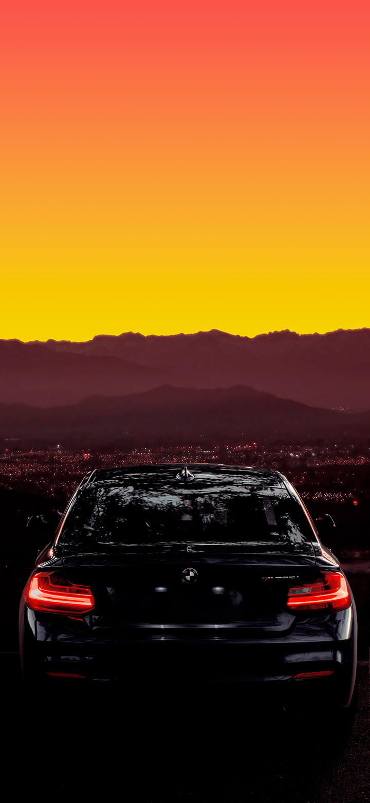 wallpaper of Cool BMW On Road At Sunset