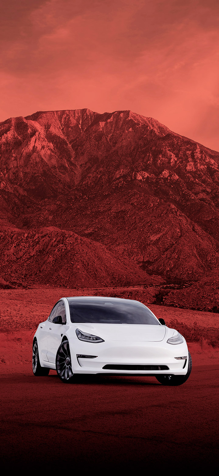 wallpaper of Tesla Parked In Front Of Red Mountain